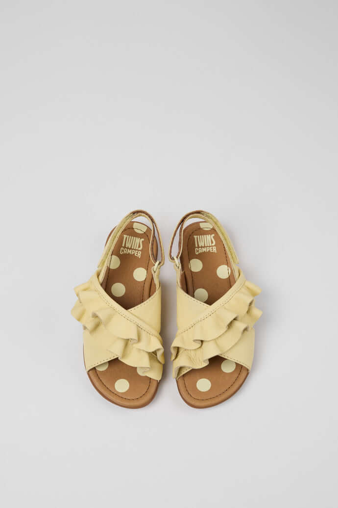 Yellow polka dot kids sandals with ruffles, perfect gift from Acorn & Pip for stylish little ones.